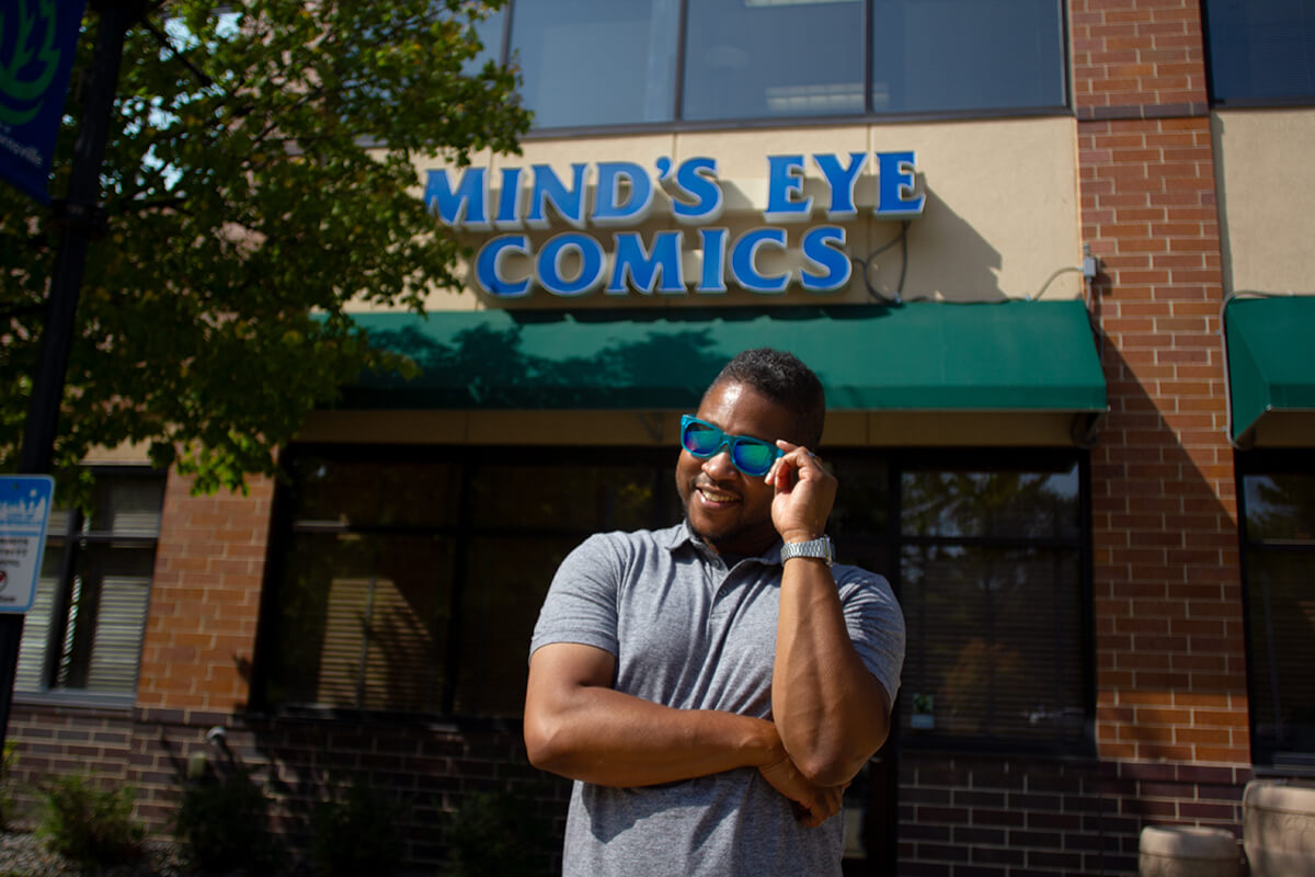 Eric Childs, MNCBA Secretary and Panel Moderator, at Mind's Eye Comics photo of Eric Childs standing inside Mind's Eye Comics